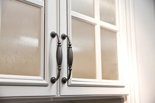 Kitchen cabinets’ windows are covered with a frosted version of decorative films to add privacy.