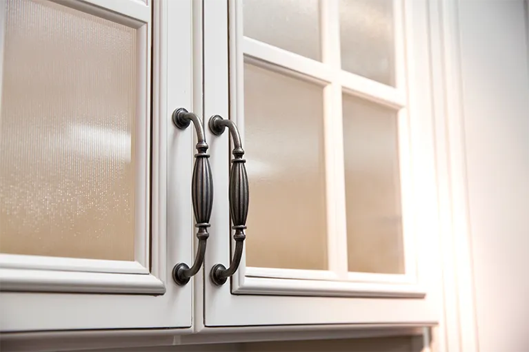 Kitchen cabinets’ windows are covered with a frosted version of decorative films to add privacy.