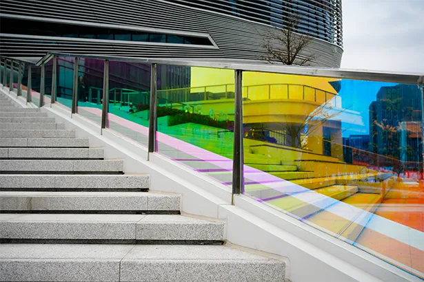 Dichroic glass on a window pane railing adds color and interest.