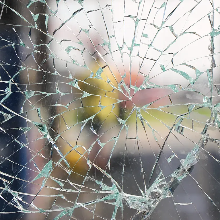 Shattered window in which the glass is held together by a safety film.