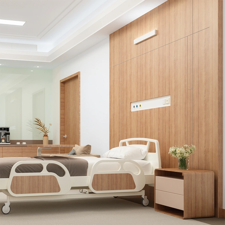 Wall panels, bed panels, counter tops and tables of a hospital room are covered in a architectural finish for a modern look.